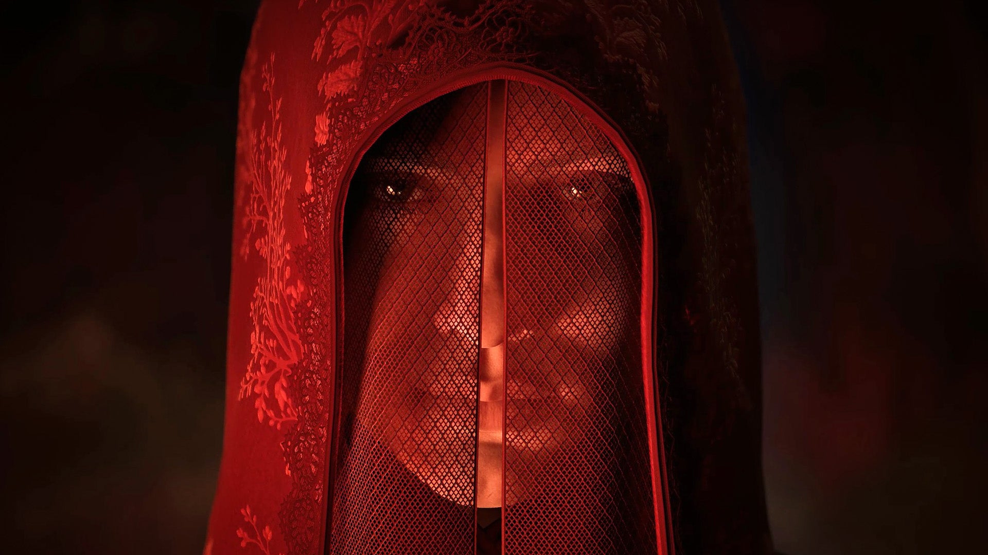 Person Wearing a Red Lace Hood and Mesh Face Veil Revealing Only Their Eyes in Red Light