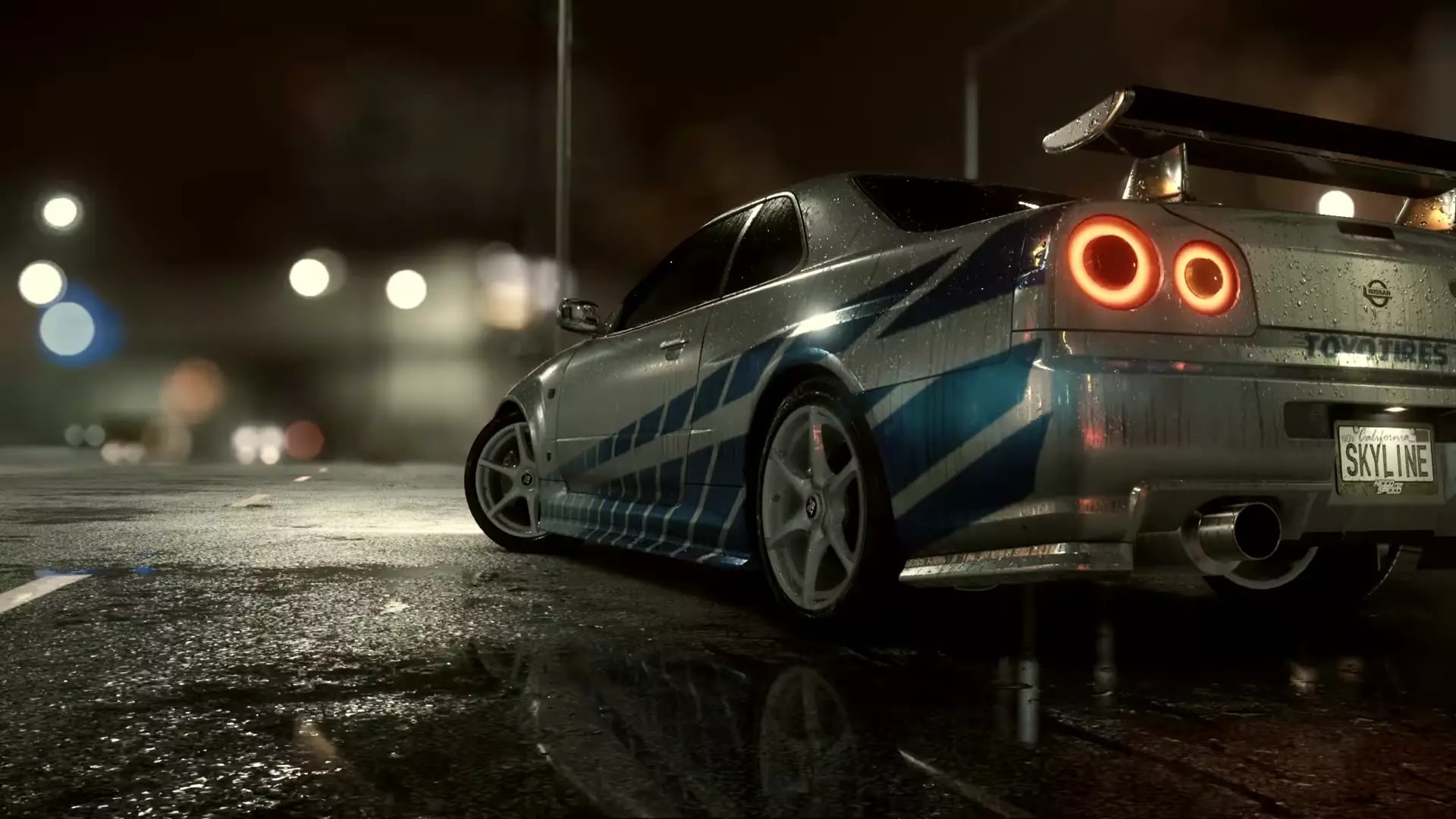 Night Scene of a Silver blue Sports Car with a Large Rear Wing Parked on a Wet City Street Taillights Glow in Red