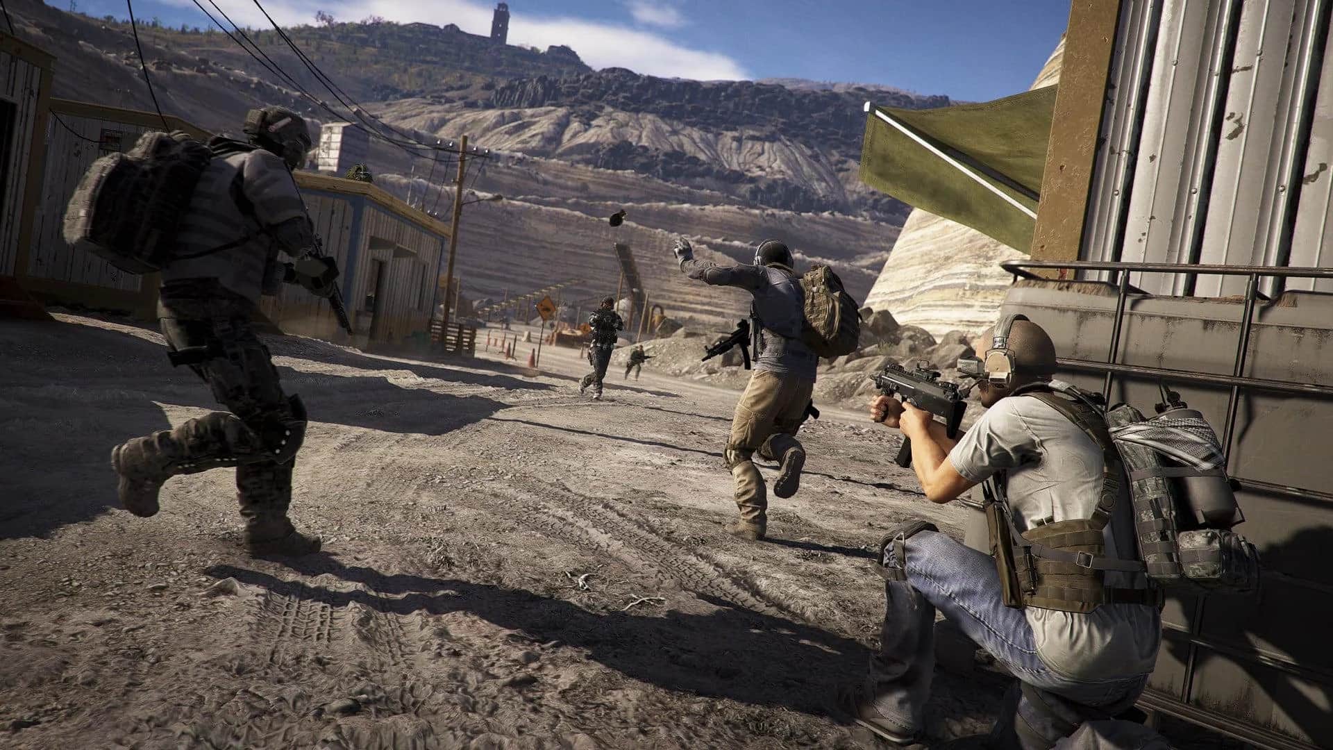 Soldiers in Tactical Gear Fire Rifles in a Dusty Desert Street Beside a Military Vehicle
